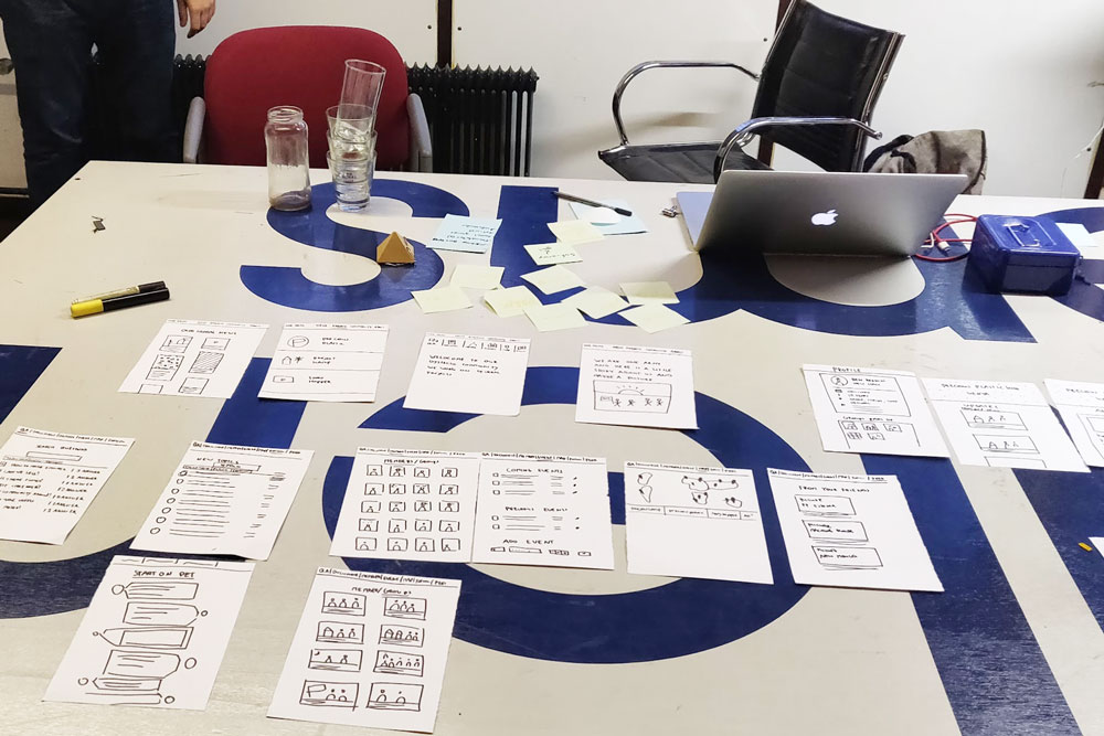 Community Platform wireframes on a table