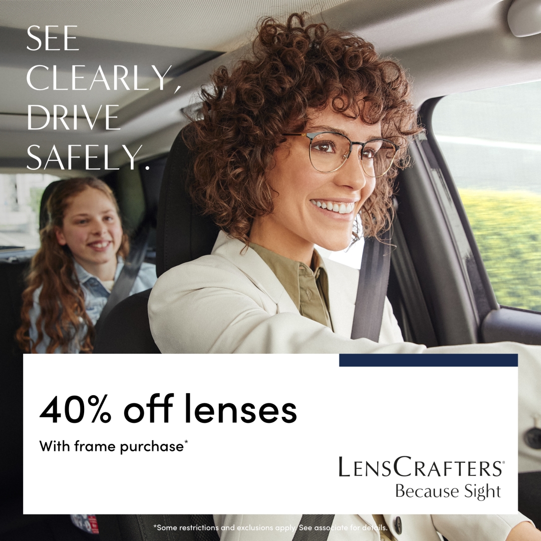 model wearing glasses with a young girl in the back seat of the car