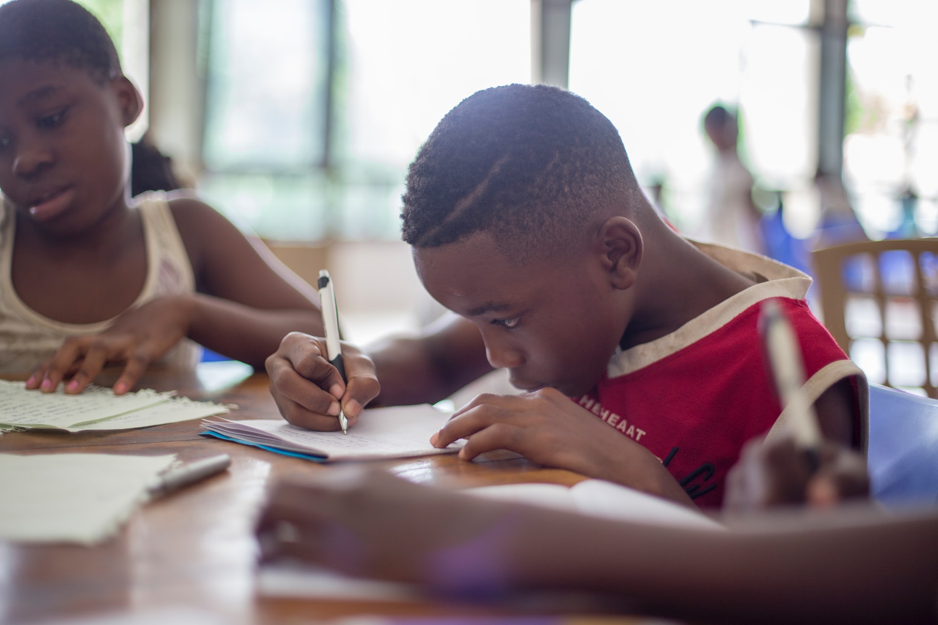A picture of a young boy completing work at school