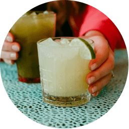 Hands holding two margaritas