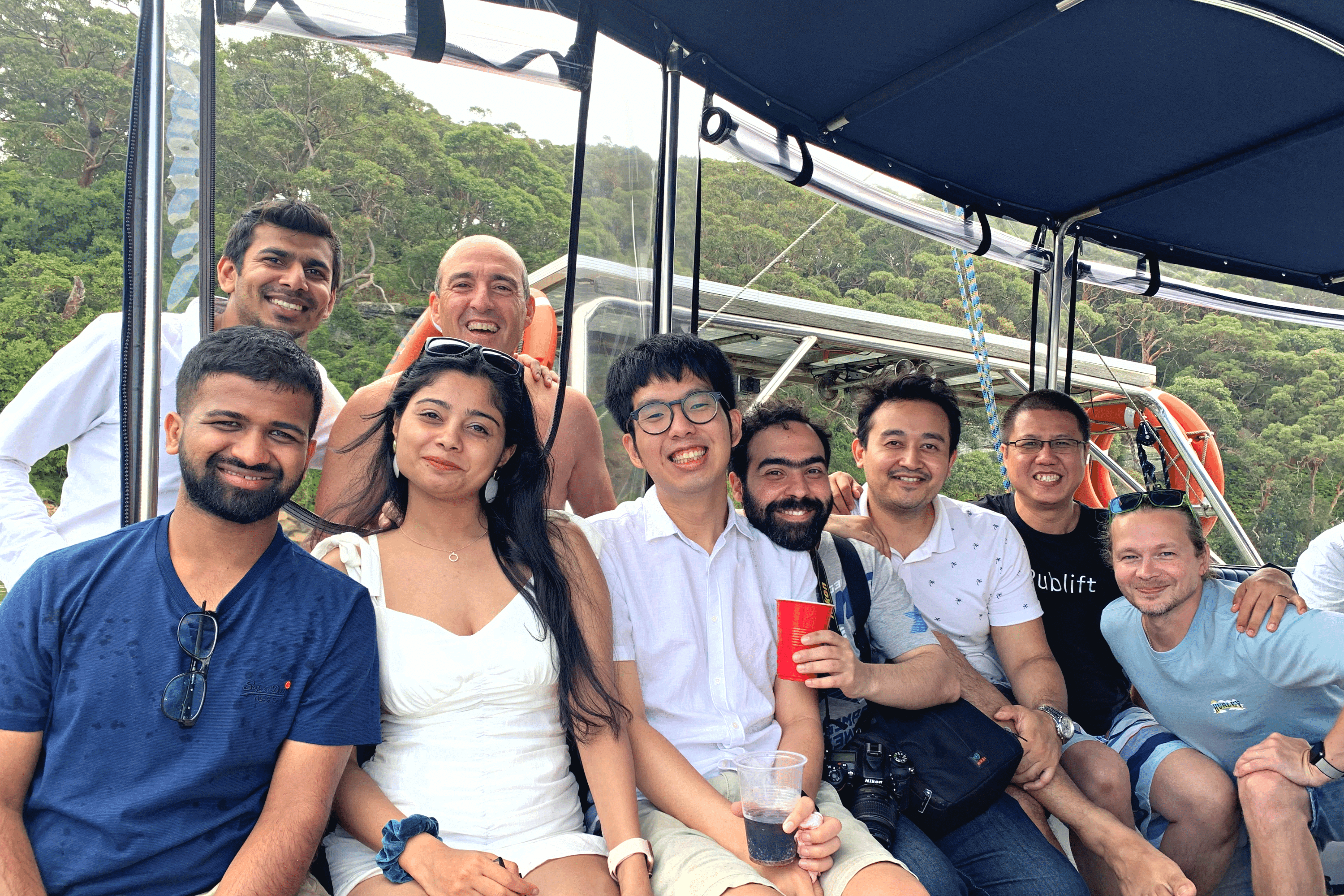 A group of people smiling on a boat