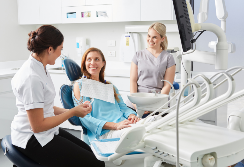 A dentist discusses tooth extraction alternatives with a patient