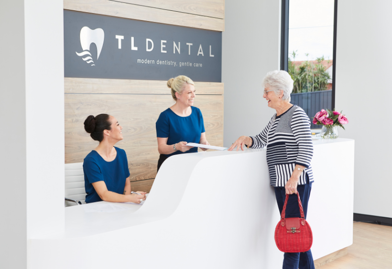 A patient receives their tooth extraction quote at TL Dental