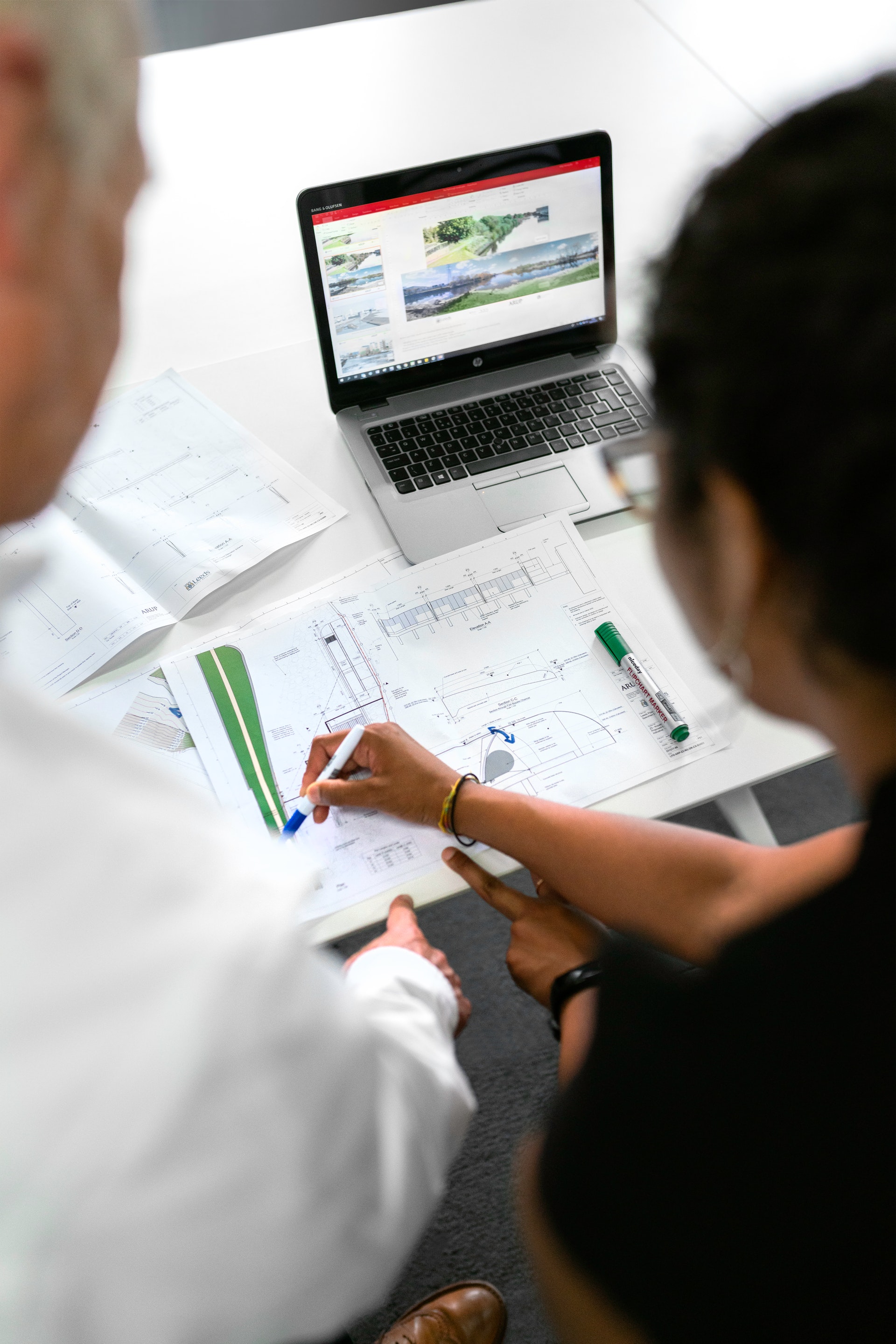 designer and contractor looking at a laptop