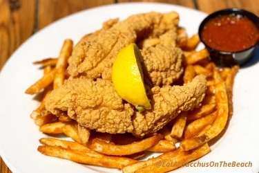 Fried Catfish with fries, sauce and a slice of lemon from Bacchus On The Beach