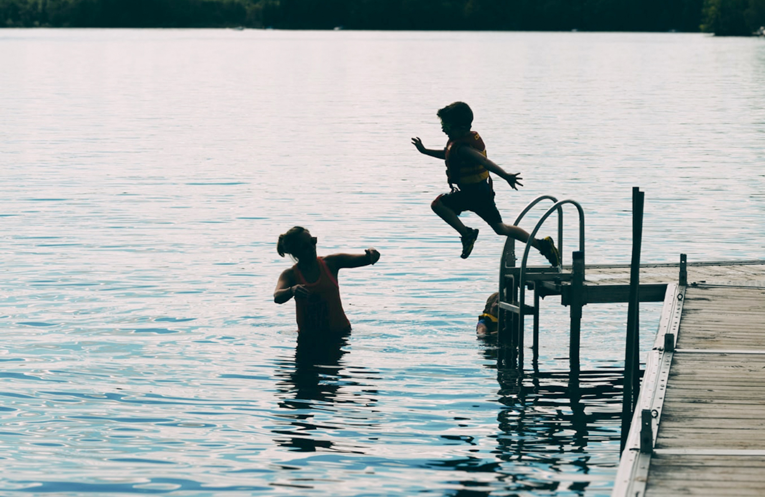 Image of mother with custody and a young boy swimming