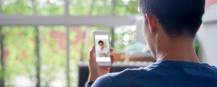 A man is video chatting with his addiction treatment counselor
