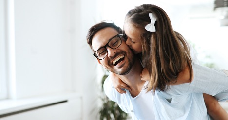 Father Giving His Daughter a Ride on His Back