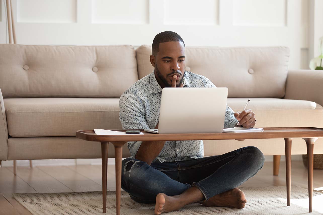 A man using his laptop and writing