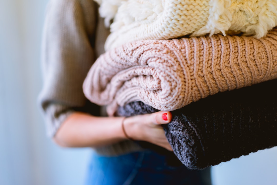 Woman carrying laundry to her new laundry room