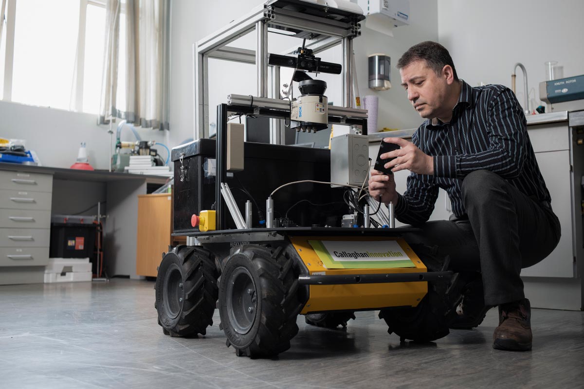 Man programming a robotic vehicle.