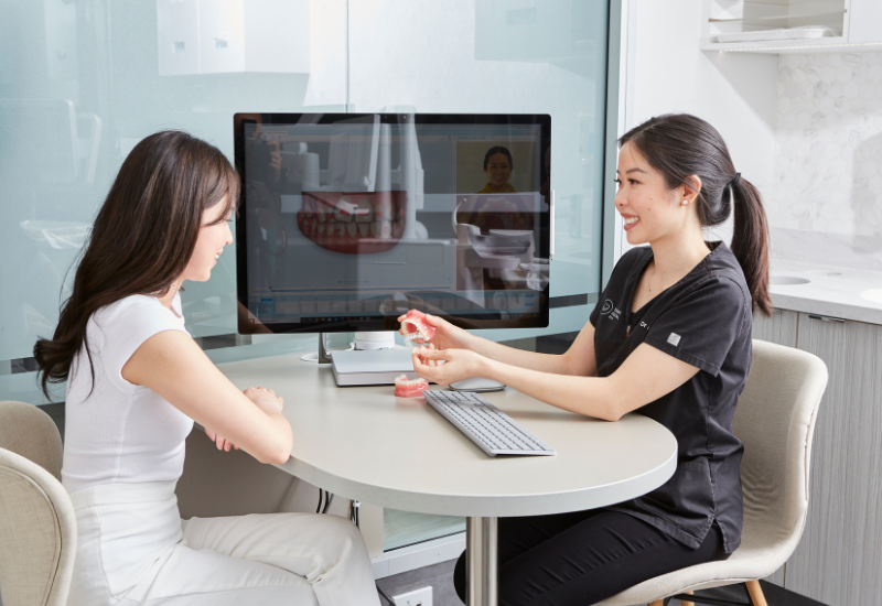 A patient discusses her Invisalign treatment plan with Dr Alice