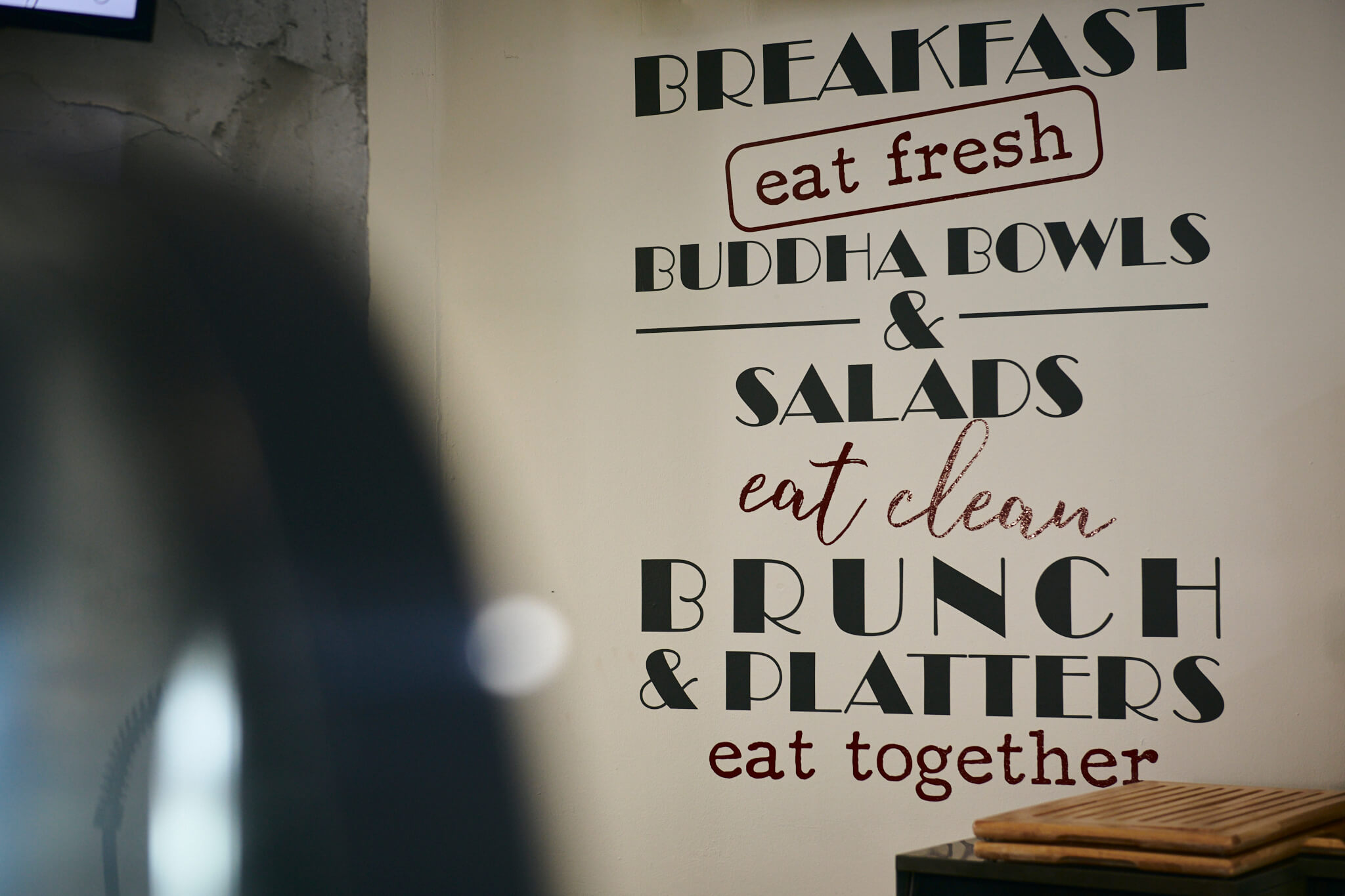 A picture of a wall in the Café that has our philosophy written on it.