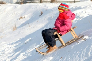 Girl sledding in the snow