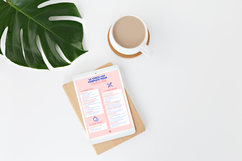 Check-list de déménagement d'entreprise rose dans une tablette blanche posée sur une planche en bois sur fond blanc avec une tasse de café au lait et un feuille de plante verte