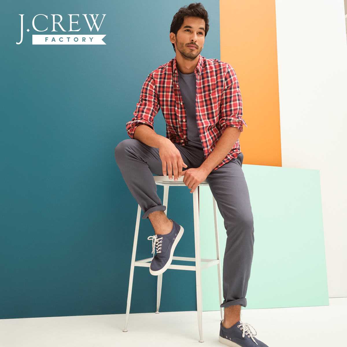 Young man wearing gray J. Crew pants and t-shirt with a red flannel shirt on top.