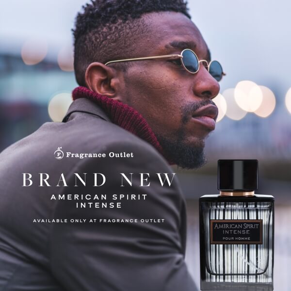 Young man wearing a suit and sunglasses with American Spirit Intense bottle