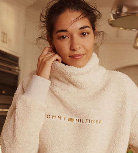 Model wearing a Tommy Hilfiger white turtleneck