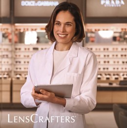 Doctor holding a tablet in the entrance of a Lenscrafters store
