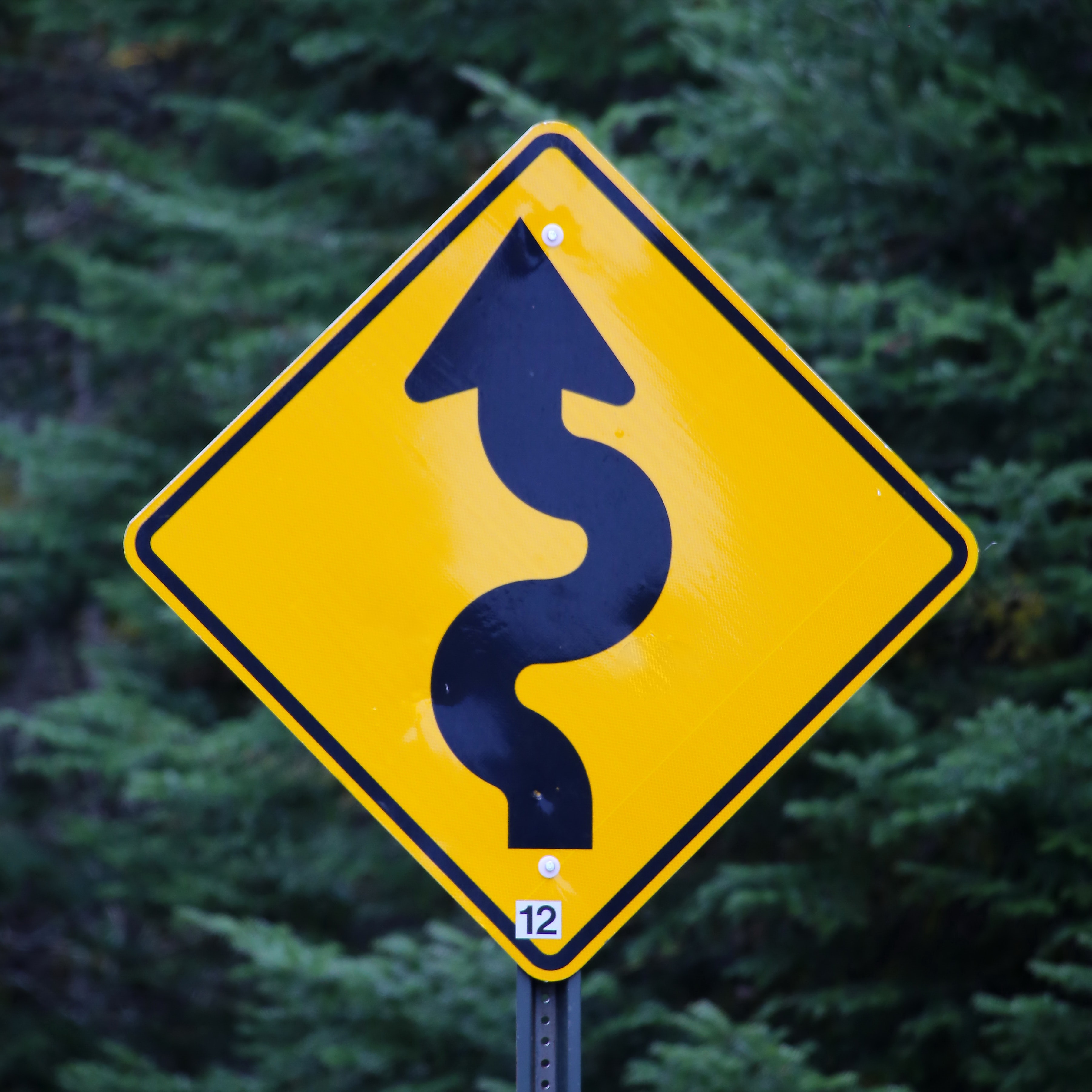 a road sign describing a long and winding road
