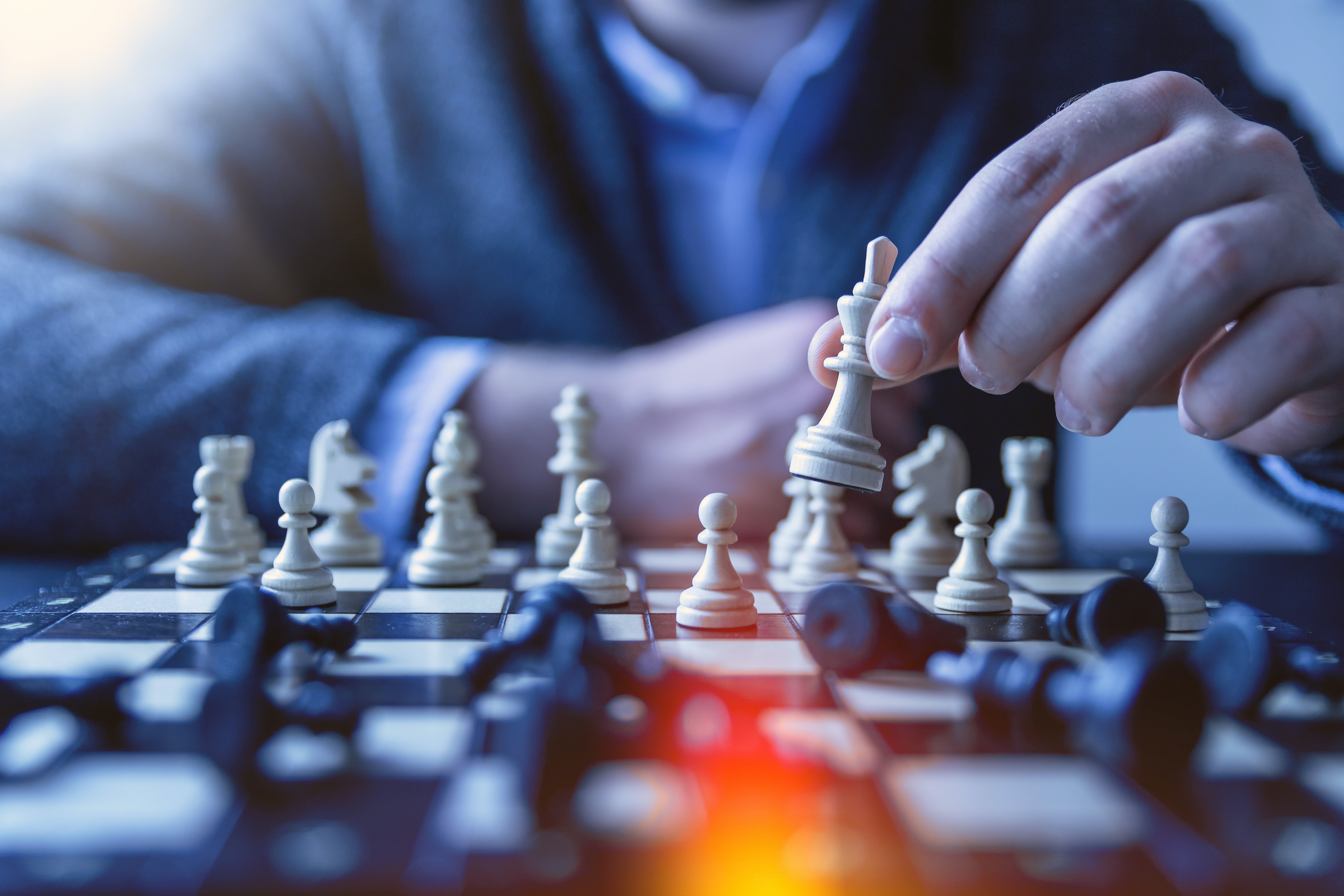 a person moving a chess piece