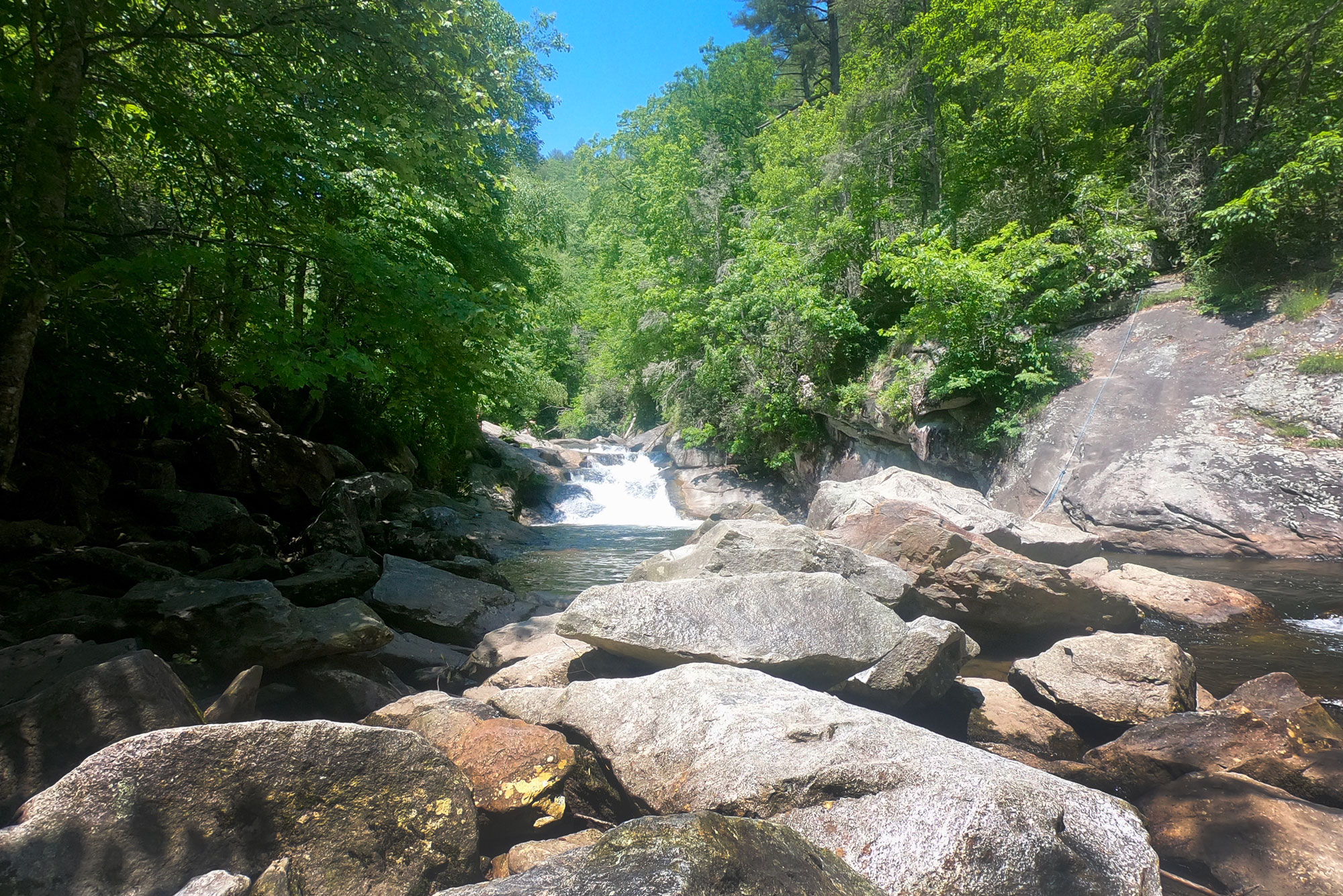 Bust Your Butt Falls swimming hole off Highway 64 near Standing Indian Campground