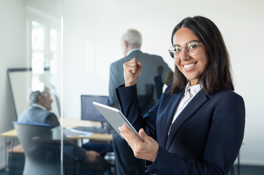 Businesswoman smiling at the camera in a happy pose in front of office