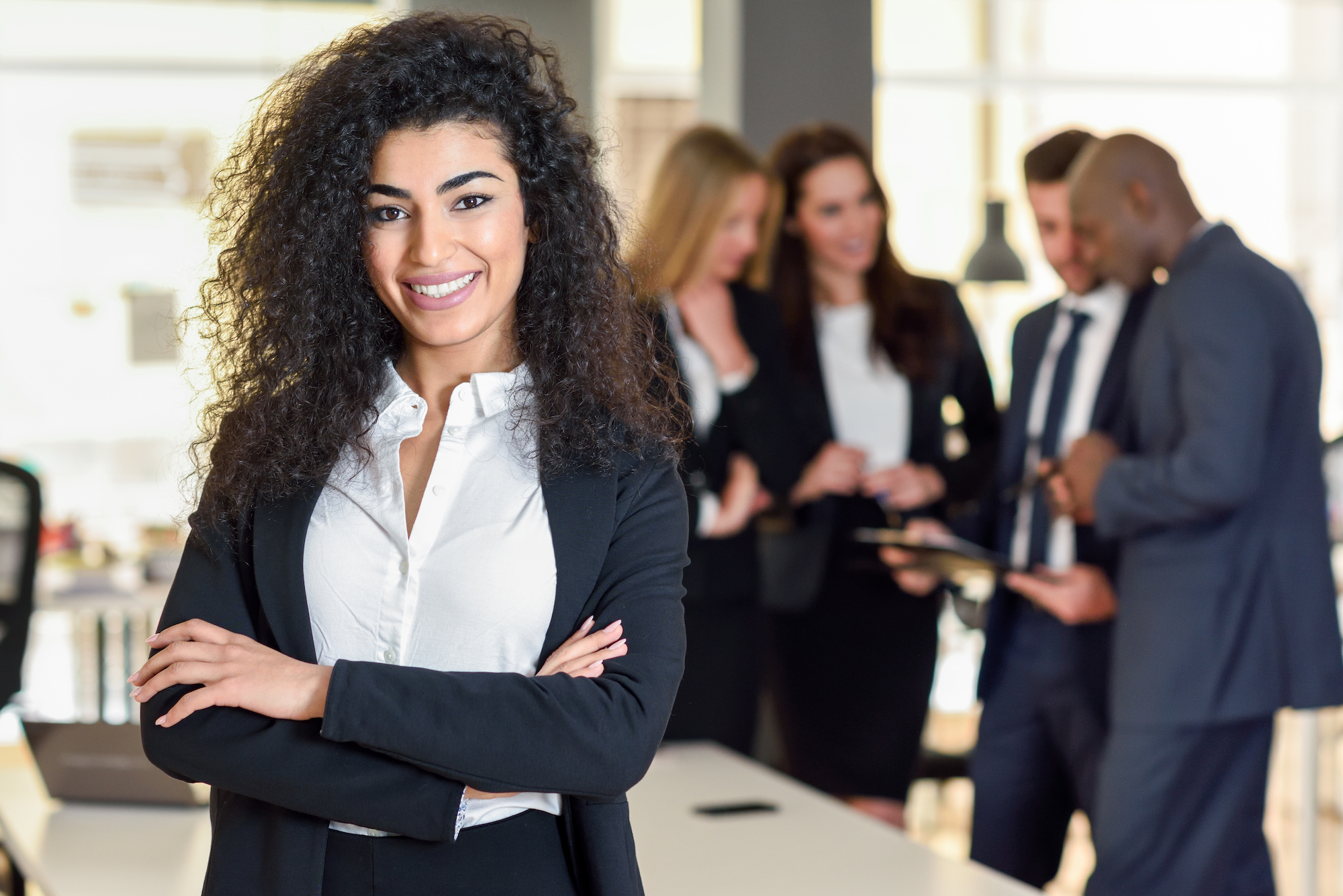Businesswoman in office with team looking to hire