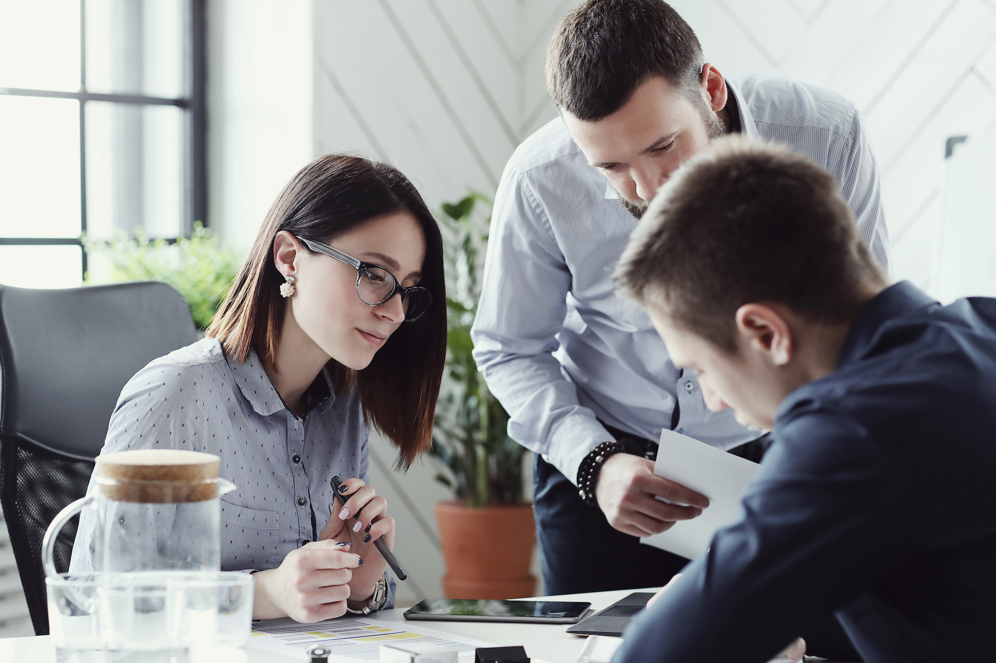 Businessmen in office with team looking to hire