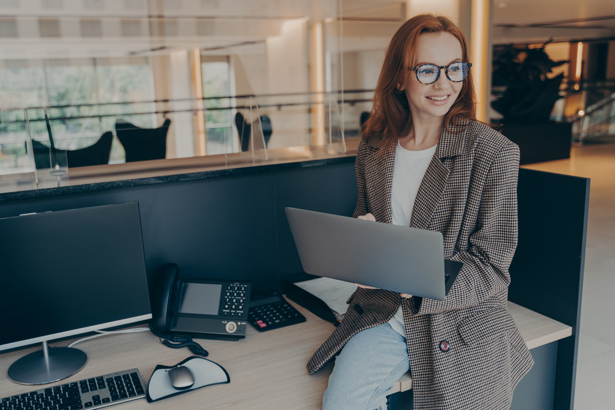 Businesswoman in office with team looking to hire