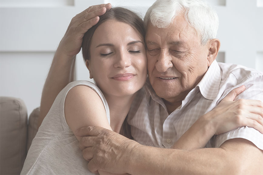 Elderly father hugging his daughter.