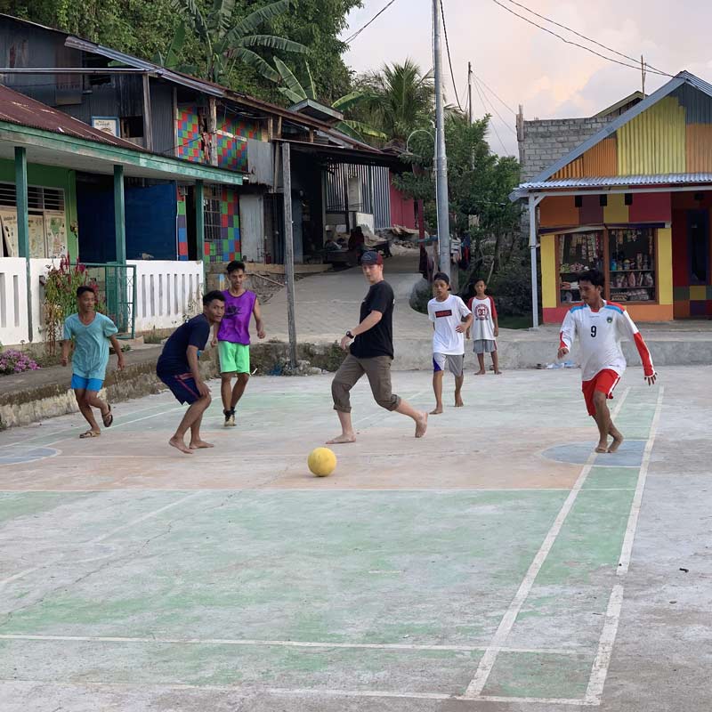 Go on your trip - a group of young men playing a casual game of soccer
