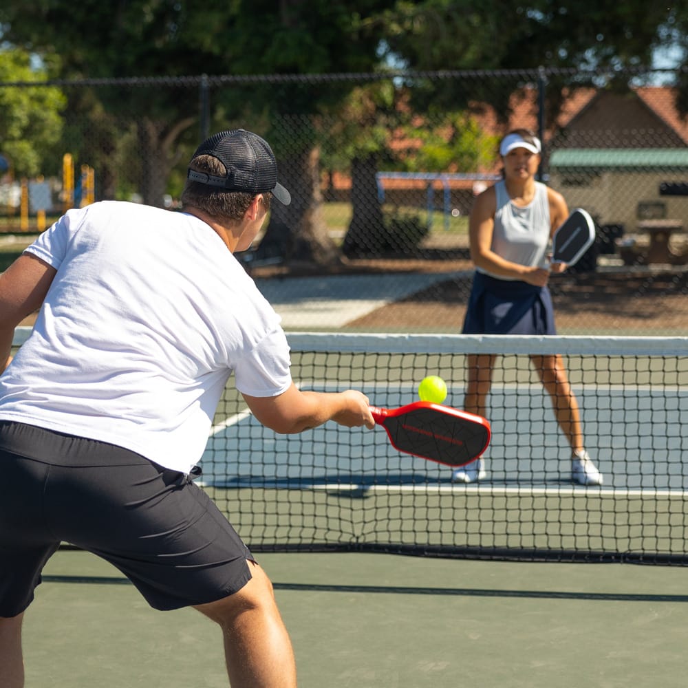 man hitting a volley in pickleball