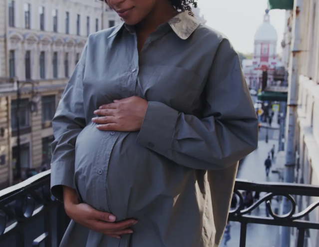 Pregnant mother holding belly