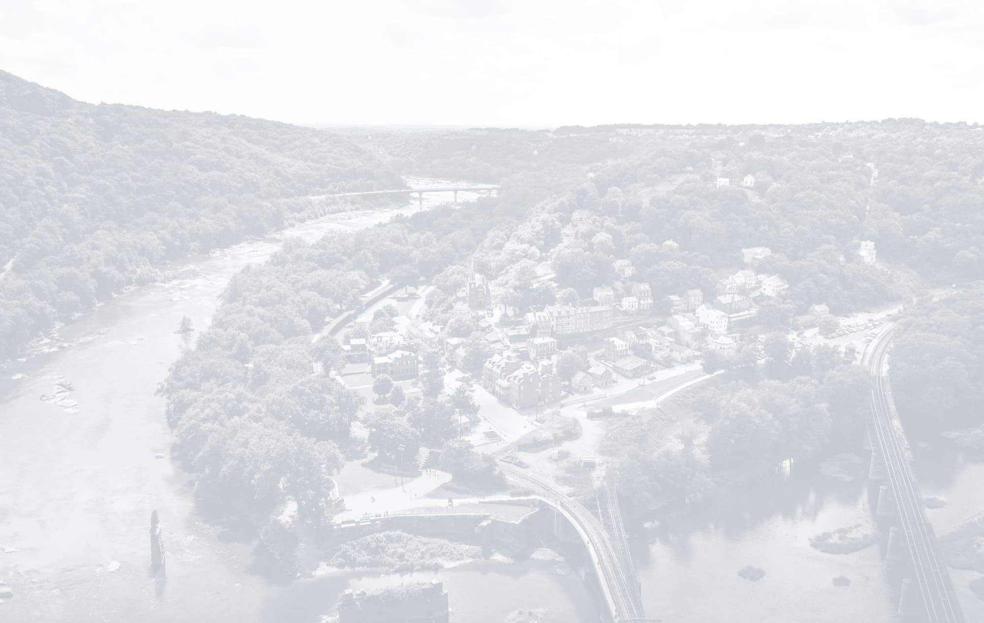 Panoramic shot of a river curving around a city's downtown area.