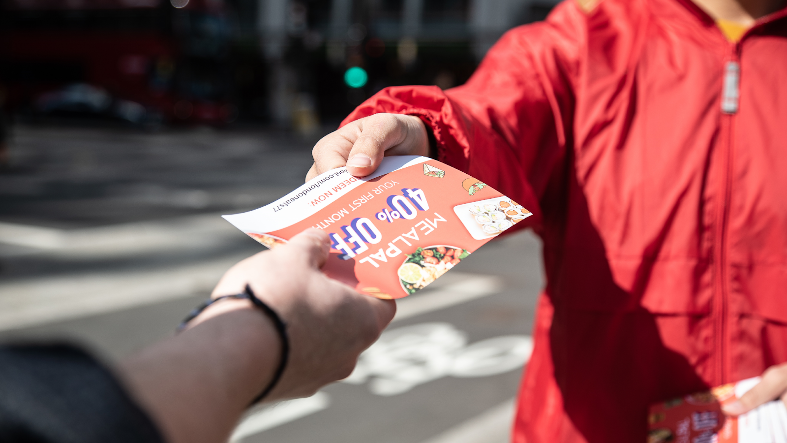 Distributing hand to hand flyers to boost brand awareness and increase reach.