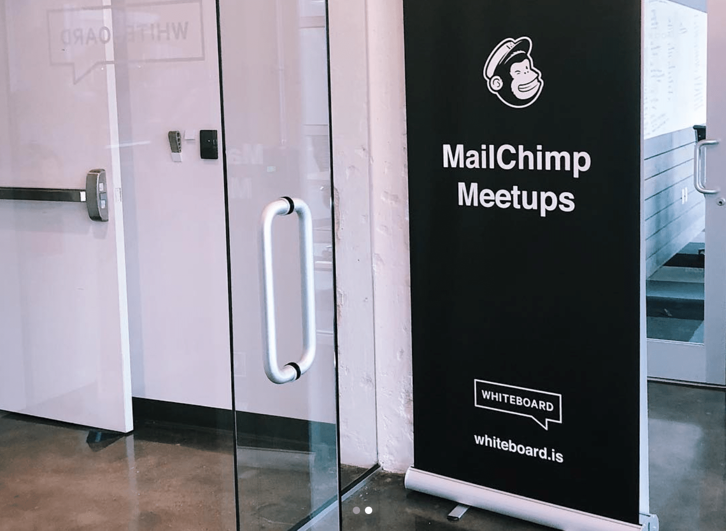 Photo of a standup flag that reads "Mailchimp Meetups"