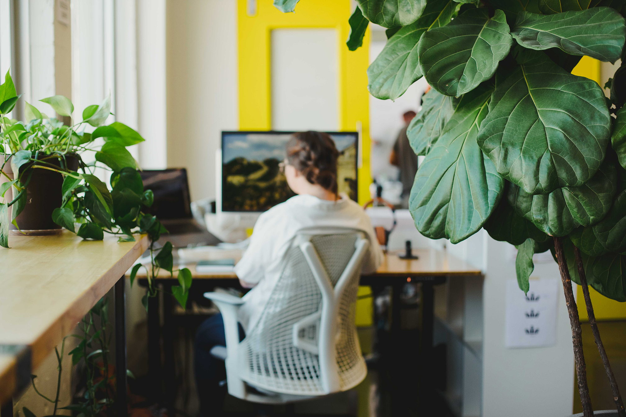 Whiteboard employee Grace Gorst works at her desk.