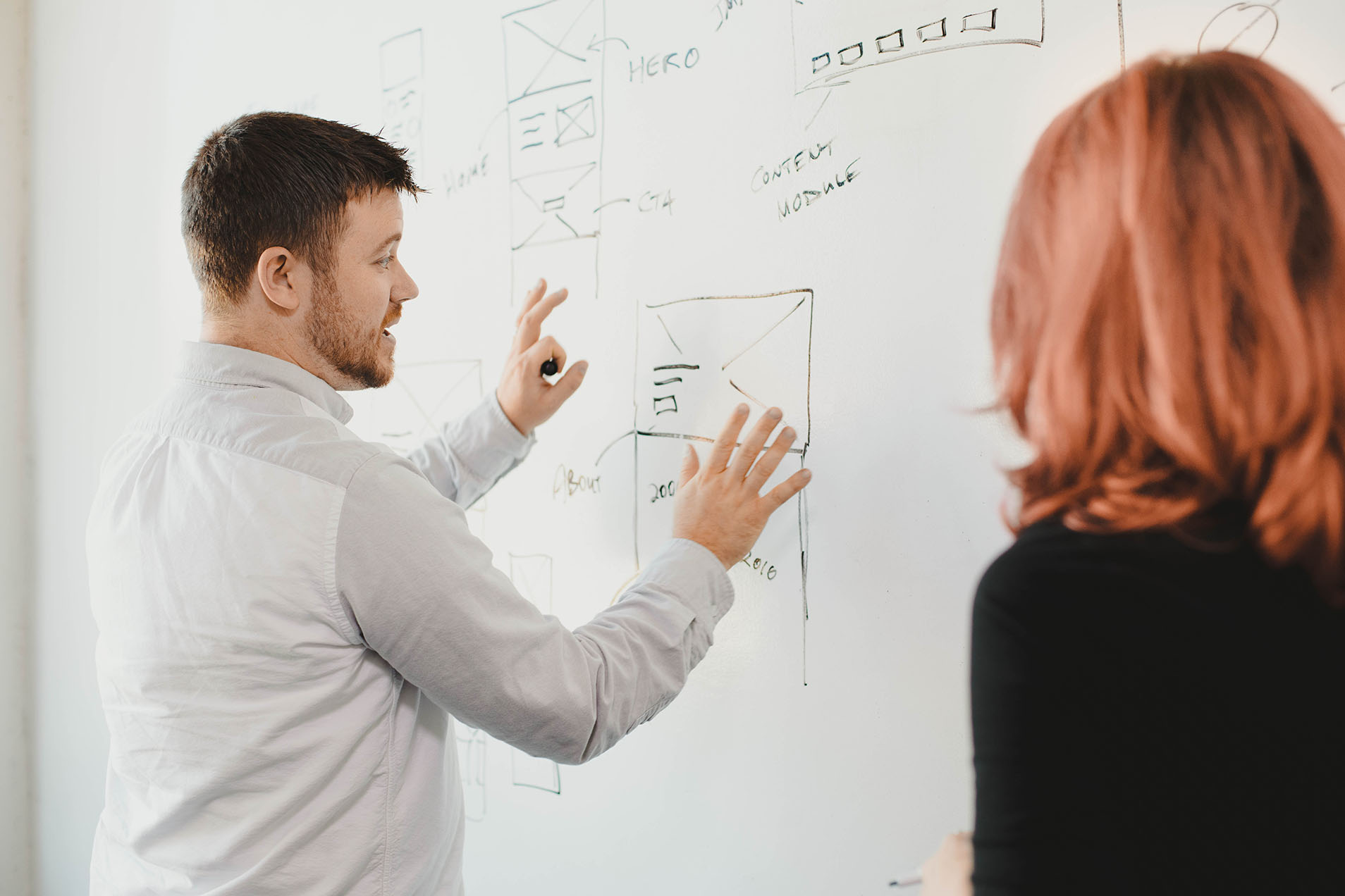 Whiteboard co-founder Eric Brown leads a war room, gesturing in front of a filled whiteboard