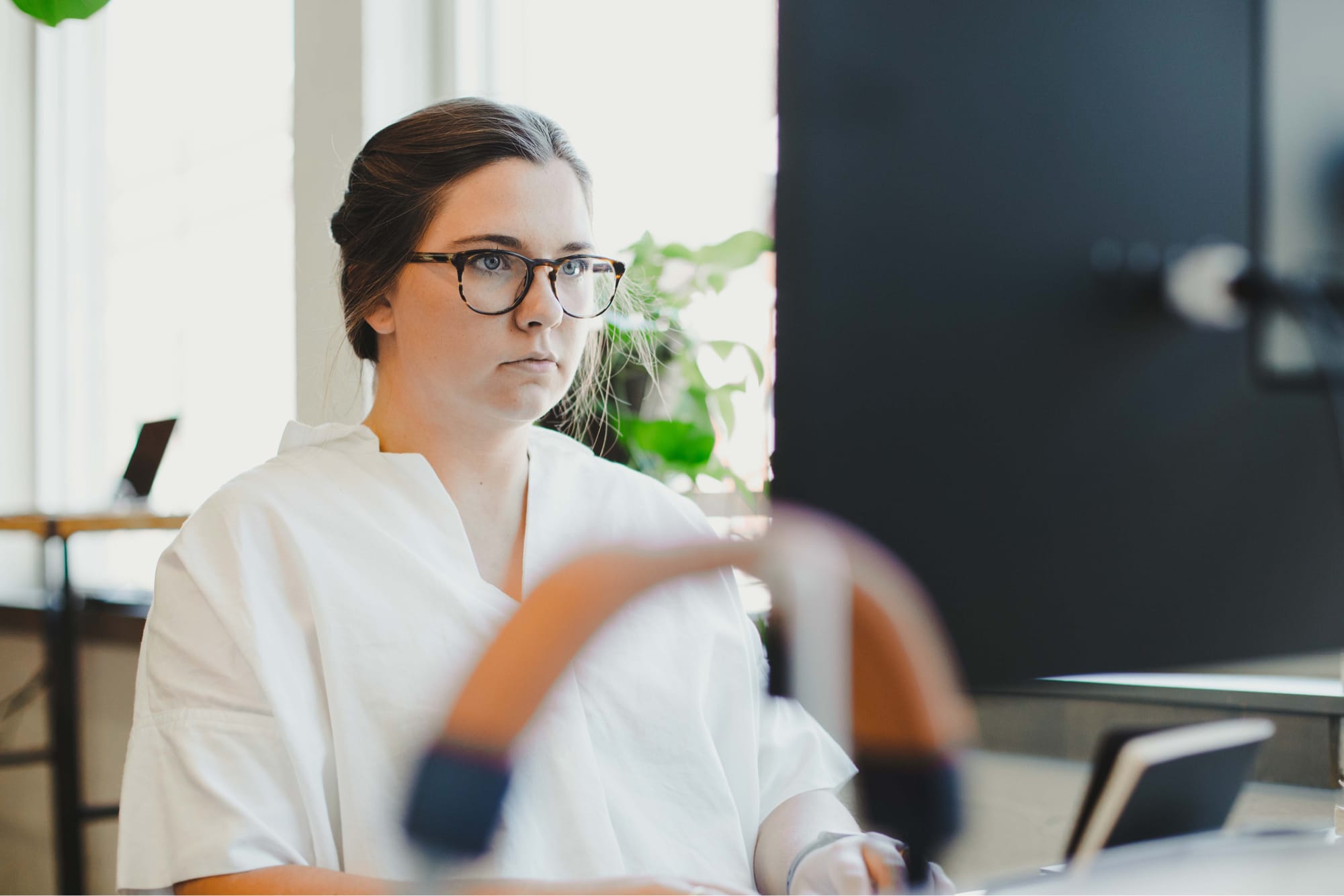 Grace Gorst works at her computer station in the Whiteboard office.