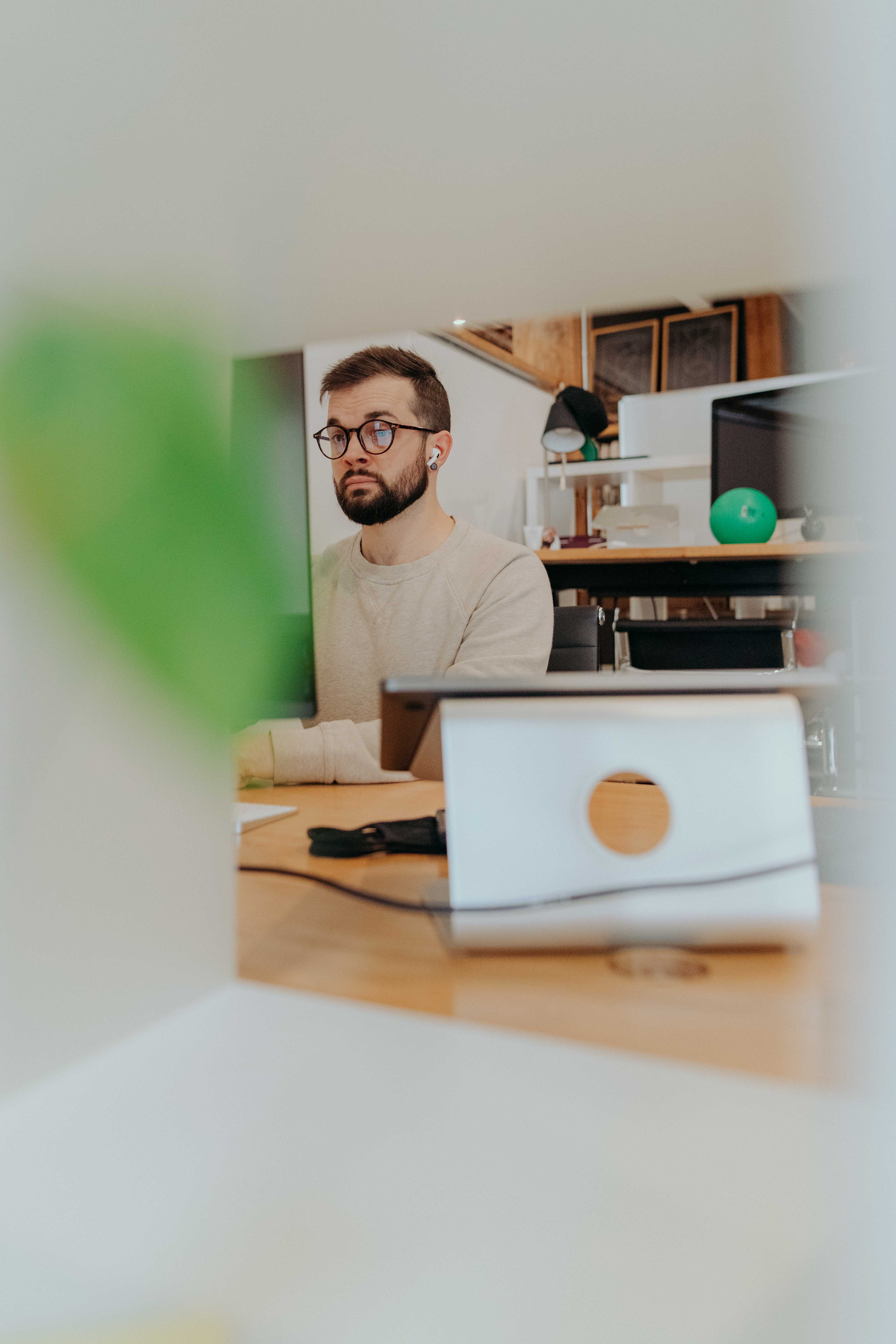 Nick Blackmon, whiteboard employee, works at his computer station.
