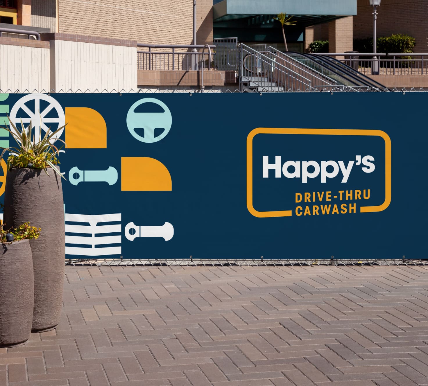 A mockup showing the Happy's Car Wash on a wall decal.