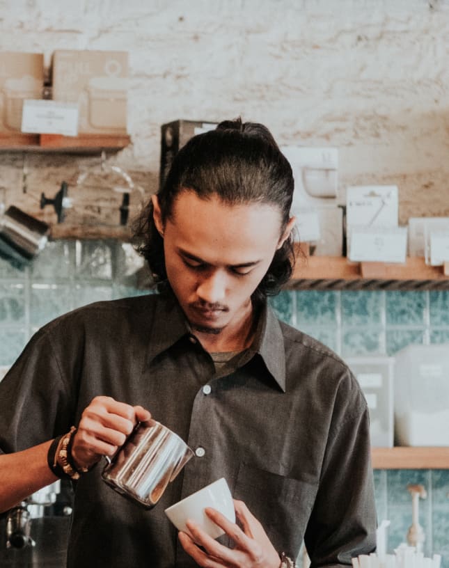 A barista prepares coffee.