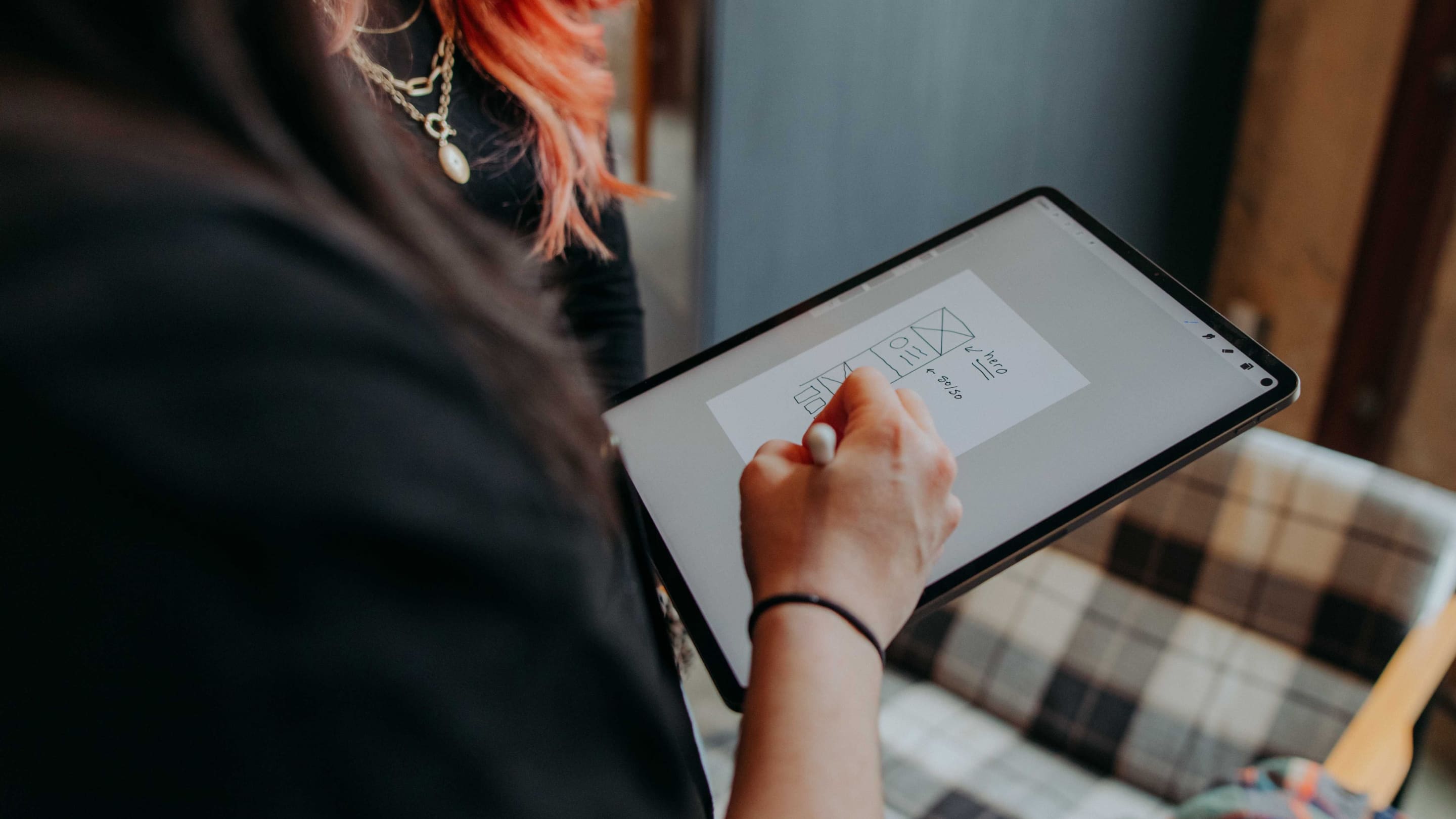 A Whiteboard employee examines work on a tablet.