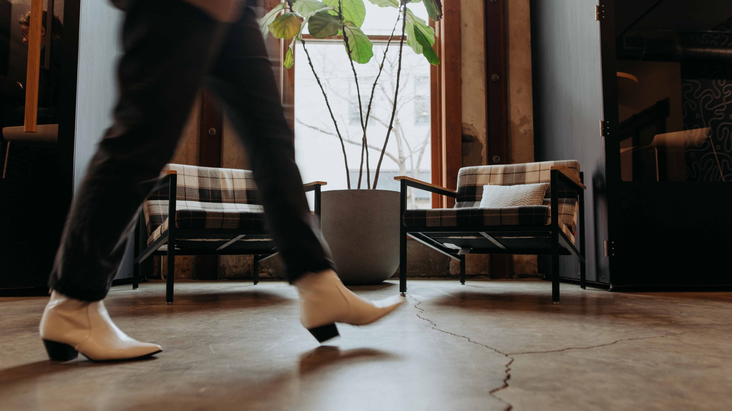 A Whiteboard employee walks across the office.
