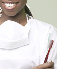 Smiling dentist with a toothbrush