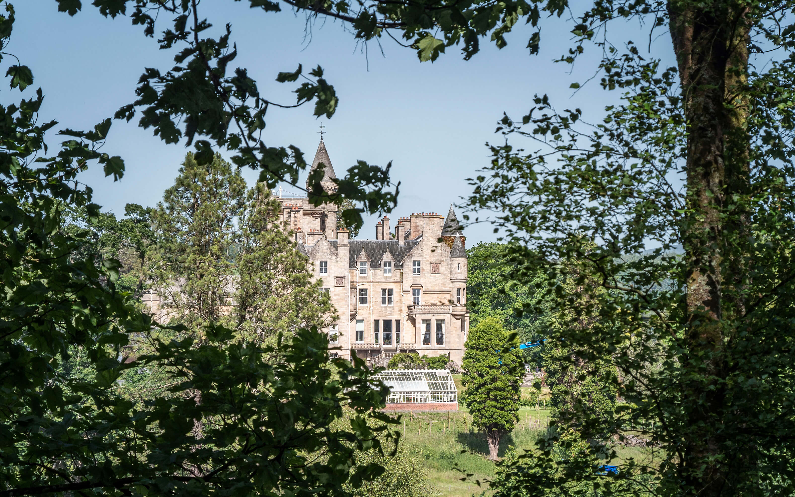 A view of Camphill House though the trees.