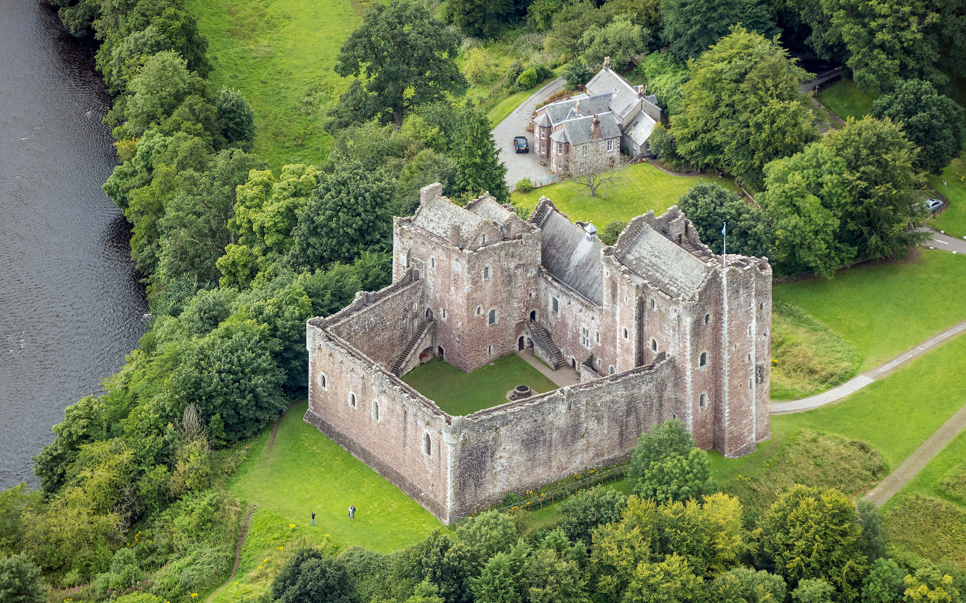 A dramatic aerial photograph of Doune Castle.