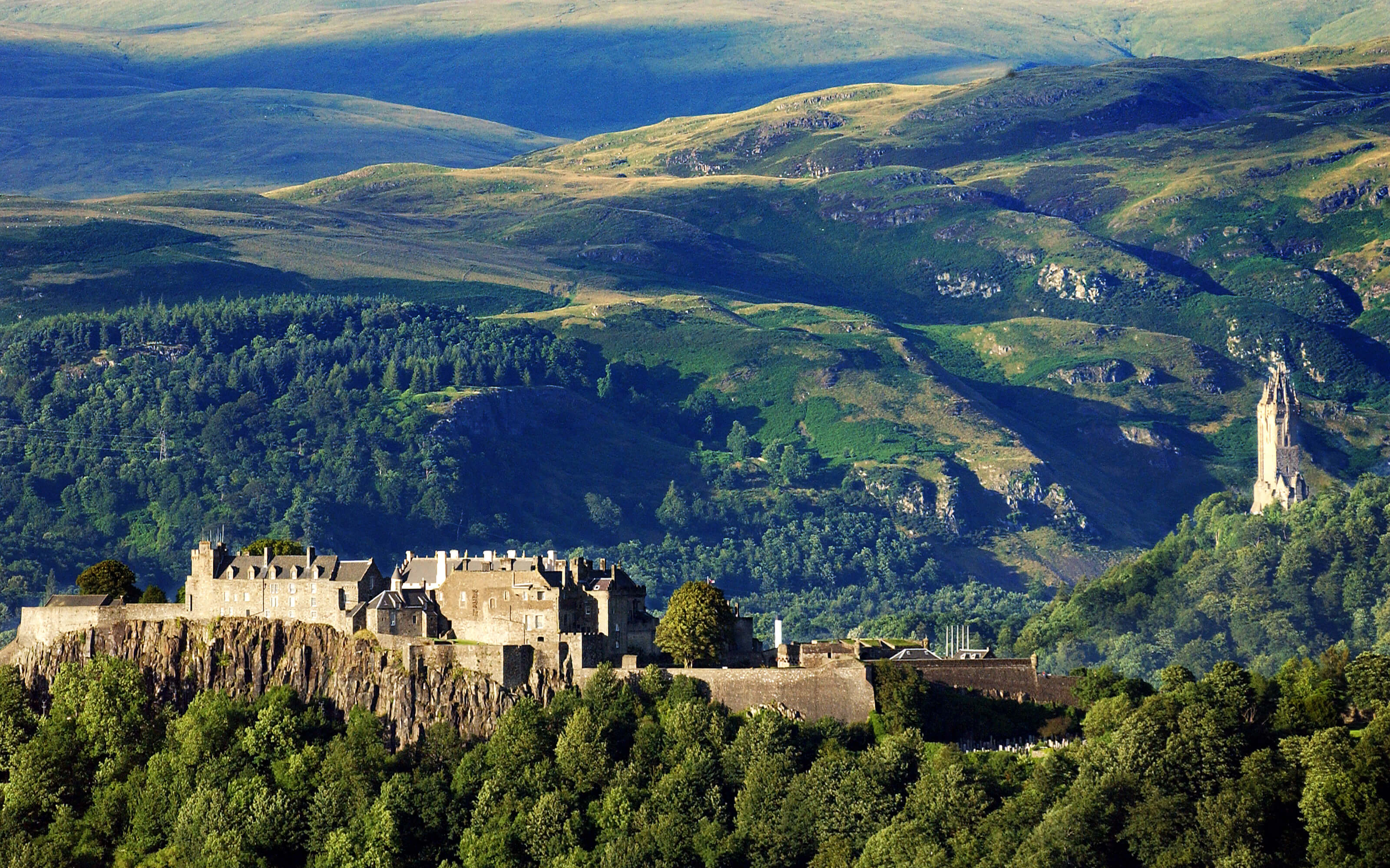 A dramatic photograph of Stirling Castle with the Wallace Monument.