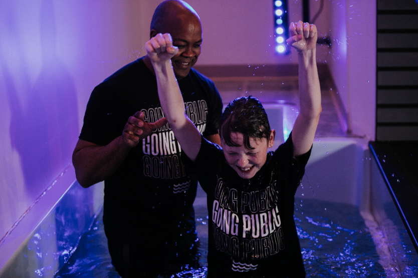 Kid getting baptized